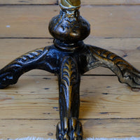 Lions paw close up on an Antique Victorian brass telescopic wine table with mahogany top and lion’s paw feet