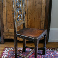 Carved elm hall chair circa 1900 with hide seat front view