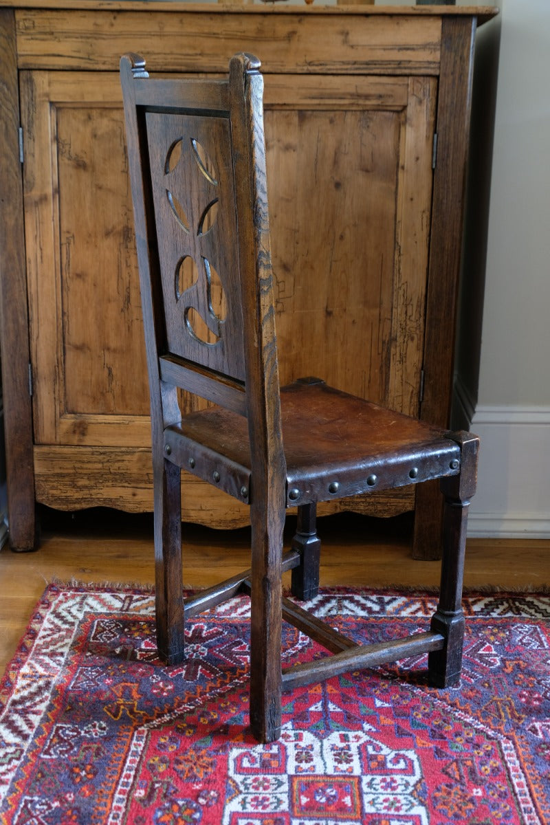 Carved elm hall chair circa 1900 with hide seat front view