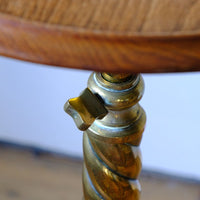 close up of the brass locking thumb screw on an Antique Victorian brass telescopic wine table with mahogany top and lion’s paw feet
