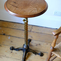 Top down view on an Antique Victorian brass telescopic wine table with mahogany top and lion’s paw feet