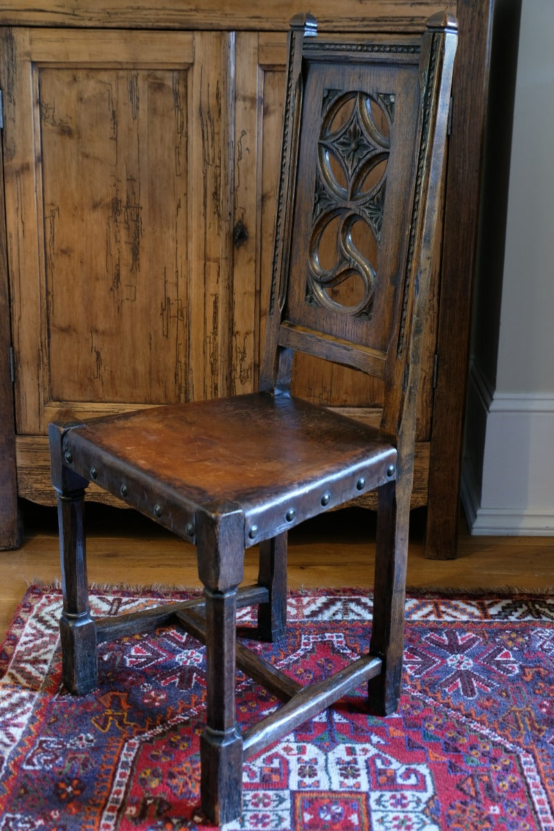 Carved elm hall chair circa 1900 with hide seat front view