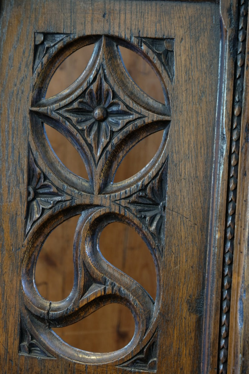 Intricate circular pierced backrest of elm hall chair