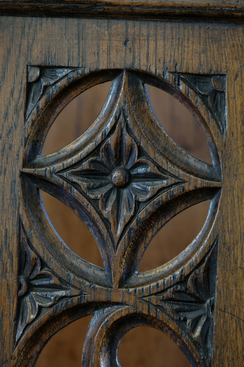 Intricate circular pierced backrest of elm hall chair
