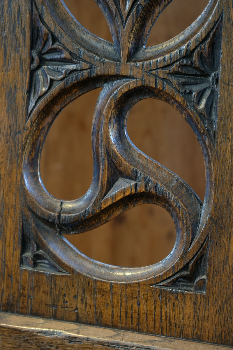 Intricate circular pierced backrest of elm hall chair