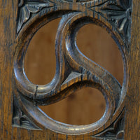 Intricate circular pierced backrest of elm hall chair