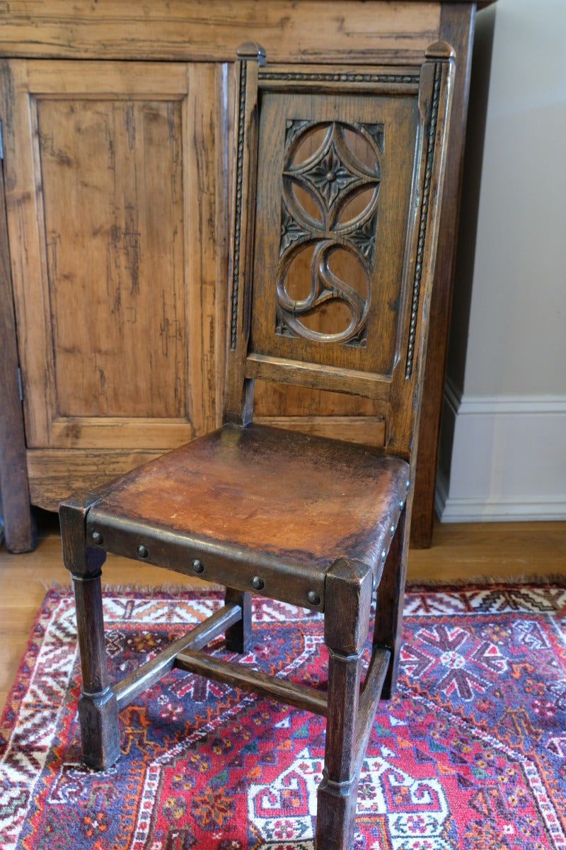 Intricate circular pierced backrest of elm hall chair