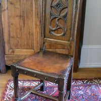 Intricate circular pierced backrest of elm hall chair
