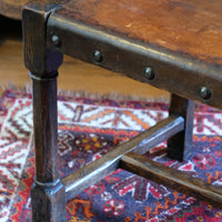 Hide upholstered seat with brass studs on antique elm chair