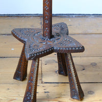 Star shaped carved base of a Rare Arts & Crafts Carved Oak Ratchet Adjustable Candle Stand