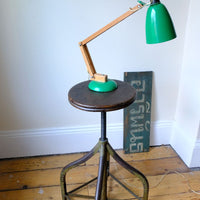Shown with a lamp on an Industrial Swivel Stool Circa 1950 | Vintage Elm & Steel Workshop Stool