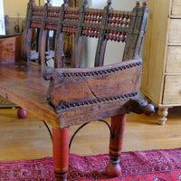 Chipped carved arm support on a Late 19th Century Gujarati Hardwood Hall Bench with Original Polychrome Finish, Turned Gallery Back and Brass Rosette Mounts
