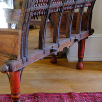 The back is as important as the front on this Late 19th Century Gujarati Hardwood Hall Bench with Original Polychrome Finish, Turned Gallery Back and Brass Rosette Mounts