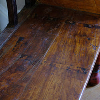 Close up of the bench seat on a Late 19th Century Gujarati Hardwood Hall Bench with Original Polychrome Finish, Turned Gallery Back and Brass Rosette Mounts