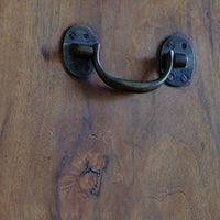 Brass drop handle on the Camphor Wood Campaign Secretaire Chest by Phelps Ltd. with Fitted Writing Desk and Original Label