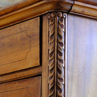 Curved corner top and carved pilaster on the Camphor Wood Campaign Secretaire Chest by Phelps Ltd., c.1890–1915