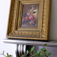 Angled view of an English School antique oil on board still life of garden flowers in original gilt carved frame