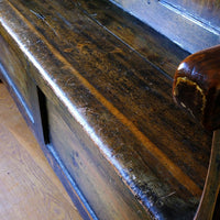 Seat detail on a 19th Century Welsh Oak Settle Bench with Painted Panels and Storage Chest