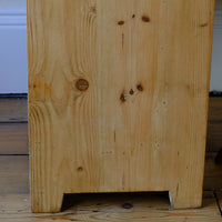 close up of the cut side panel on a Late Victorian pine marble top bedside cupboard with Carrara marble and concealed brass pivot hinges