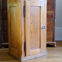 he projecting face frame, rebated lift-off door, unusual sprung refrigerator-style latch, stop chamfered corners and restrained moulded detailing combine to create a cupboard that rewards close inspection. These practical engineering details are rarely encountered together on an early 20th-century pitch pine larder cupboard and reflect a level of craftsmanship beyond ordinary utility furniture.