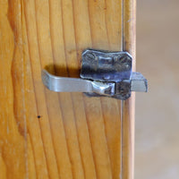 Close up of the Original sprung steel refrigerator-style latch on an Early 20th Century Pitch Pine Single Door Larder Cupboard with Lift-Off Hinges and Original Sprung Latch