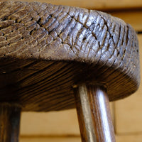 Cracked detail on an Early 20th Century Elm Milking Stool with Thick Weathered Seat and Original Patina