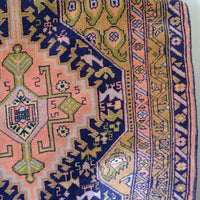 Full-length antique North-West Persian village hall runner with stepped geometric medallions and coral, indigo and ivory palette, Heriz district, c.1930–1950