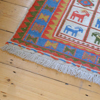 Persian Sumak flatweave rug showing wrapped-weft construction and stylised tribal motifs