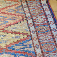 Mid-20th Century North-West Persian ivory ground hand-knotted wool runner with fourteen hooked lozenge medallions