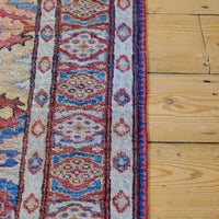 Mid-20th Century North-West Persian ivory ground hand-knotted wool runner with fourteen hooked lozenge medallions