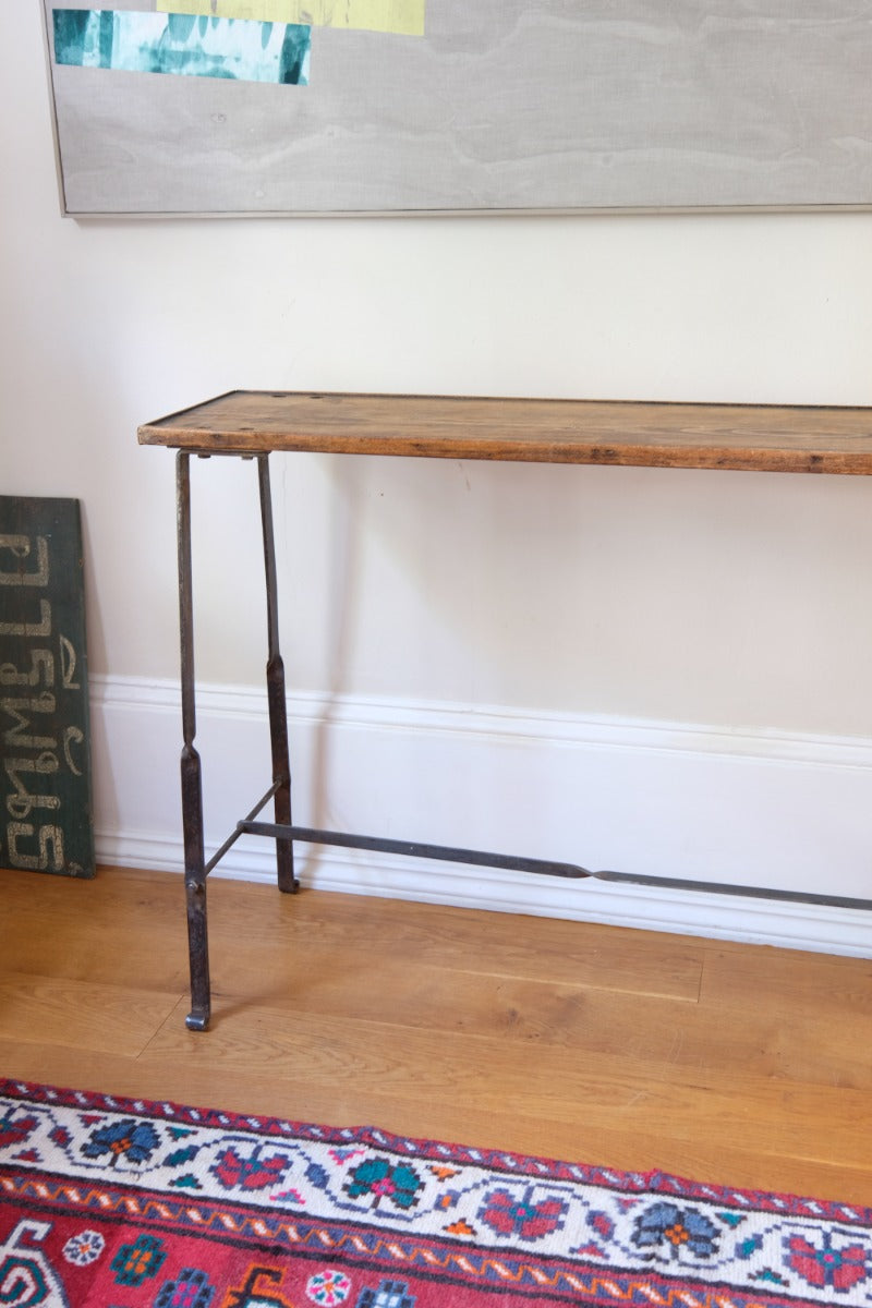 Rustic pine console table with wrought iron twisted legs and curled feet