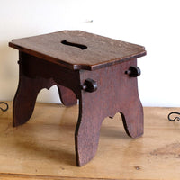 Antique Arts and Crafts oak low stool with S-shaped carrying handle, fret-cut arches and exposed keyed through-tenons, circa 1900.