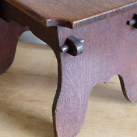Antique Arts and Crafts oak low stool with S-shaped carrying handle, fret-cut arches and exposed keyed through-tenons, circa 1900.