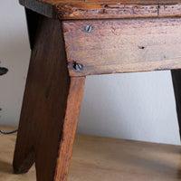 leg and screw detail on a 19th Century Vernacular Pine Stool with V-Cut Sides and Worn Grab Handle Seat