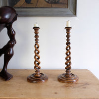 Pair of tall antique oak open barley twist candlesticks with original brass sconces and weighted circular bases