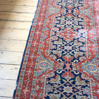Red floral main border with camel and pale blue guard borders