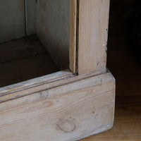 profiled plinth on the Antique pine cupboard, circa 1890–1910, with a boarded door, two pierced ventilation panels and a plinth base