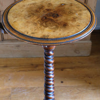 close up of the burr walnut round top on the Mid-Victorian burr walnut candle stand with fixed candle arm and barley-twist column