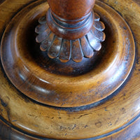 Close-up of the carved gadrooned collar, circular walnut platform base and three scroll feet of a mid-Victorian candle stand