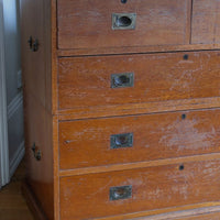 Antique campaign chest showing extensive original surface wear and aged camphor wood.