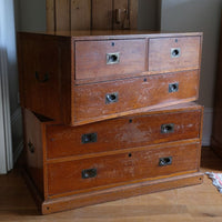 Two-part Victorian campaign chest showing folding side carrying handles.