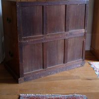 Rear of antique camphor wood campaign chest showing three-panel framed construction to both sections.