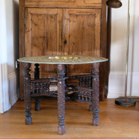 Anglo Indian folding table with brass top and carved legs