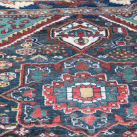 Early 20th century Persian Qashqai wool rug with indigo field, three medallions and blue-green corners, 244 × 159 cm