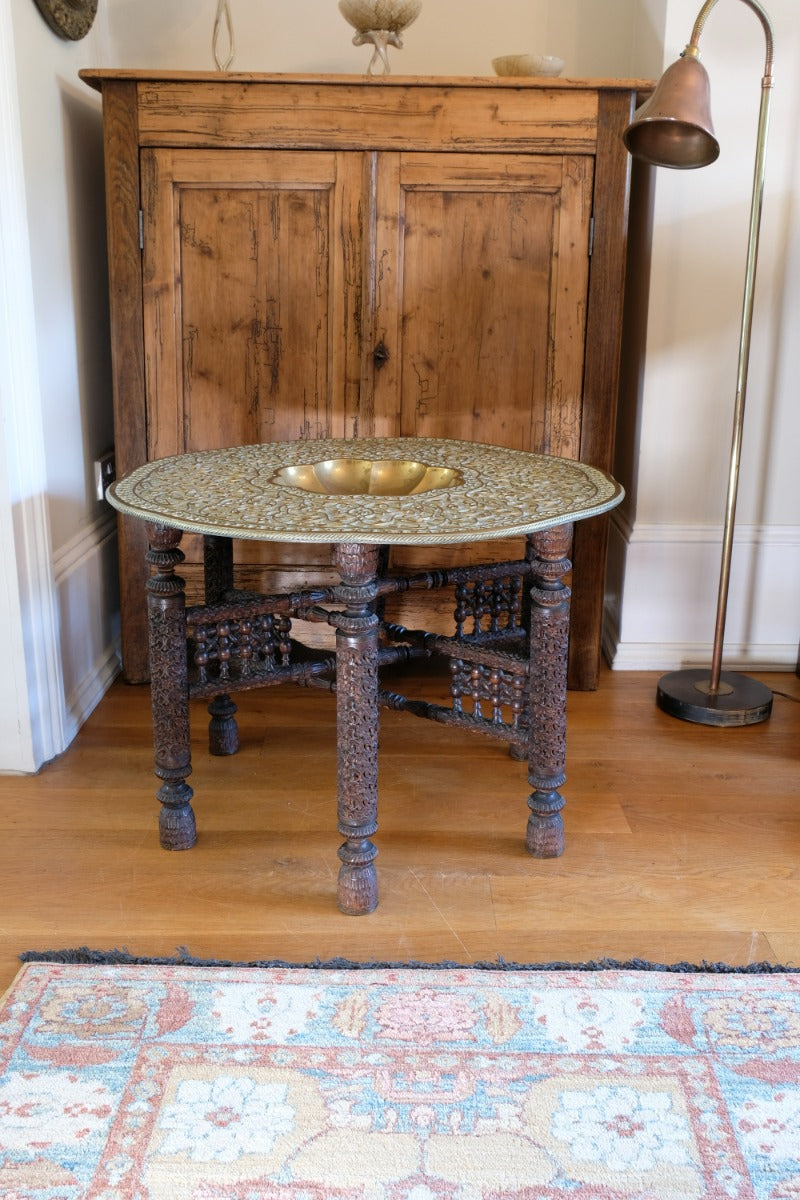 Anglo Indian folding table with brass top and carved legs