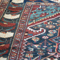 Early 20th century Persian Qashqai wool rug with indigo field, three medallions and blue-green corners, 244 × 159 cm