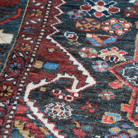Early 20th century Persian Qashqai wool rug with indigo field, three medallions and blue-green corners, 244 × 159 cm