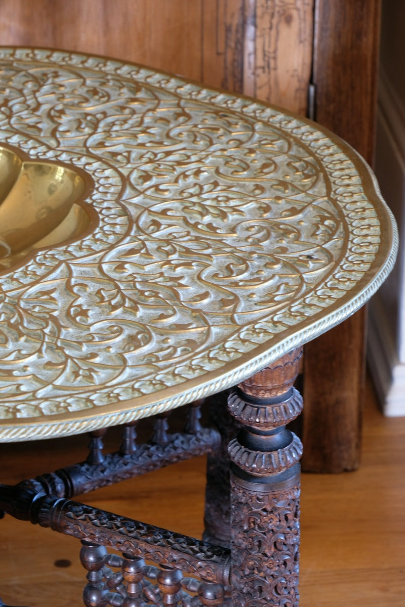Anglo Indian folding table with brass top and carved legs