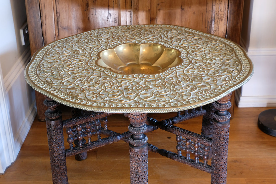Anglo Indian folding table with brass top and carved legs