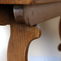Scrol end frame supports on the Arts & Crafts oak console table by Beresford & Hicks with two drawers and shaped trestle supports